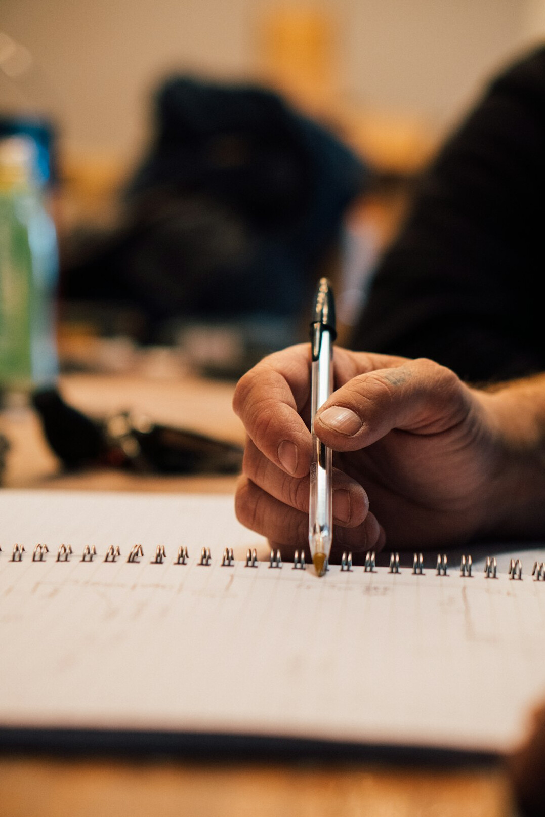 person writing in notebook